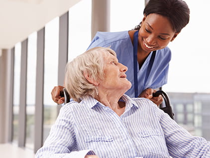 Patient being pushed in wheelchair. 