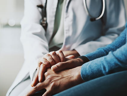 Doctor comforting a patient