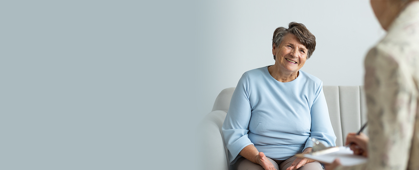 Older woman and hospital employee in a meeting.
